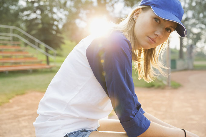 Baseball player sitting on field